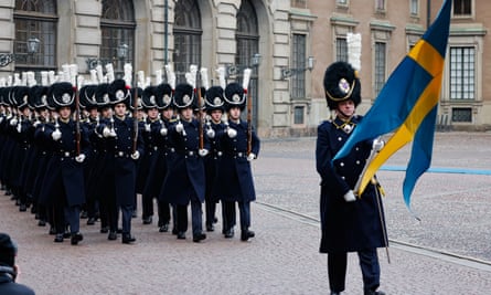Swedish Royal Guards march in the palace courtyard prior to the arrival of French president, Emmanuel Macron, and his wife Brigitte, for a Nato ceremony at the Royal Palace in Stockholm