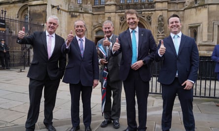 Five men stand in a row outside parliament posing for a photo with their thumbs up