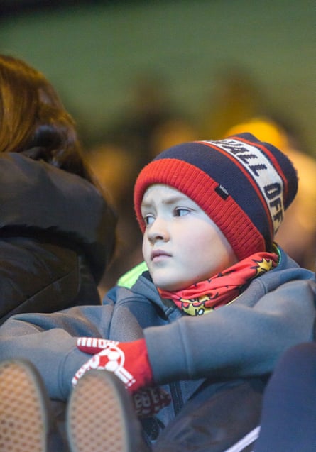A young football fan watching the game
