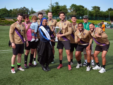 Hot Press football team receiving the winners trophy from Dublin Rose, Suad Mooge, after they won the Sport Against Racism Ireland