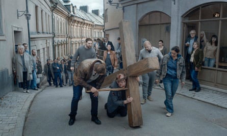 Crisis of faith … a priest dreams he is carrying a cross through the streets of Stockholm