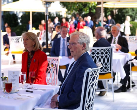 Lisa Murkowski and Mitch McConnell listen as Donald Trump delivers remarks during a luncheon in the Rose Garden of the White House.