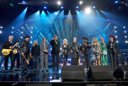Several veteran musicians on a blue-lit stage