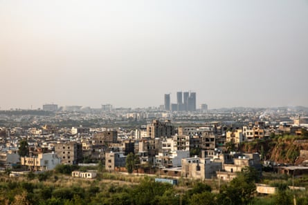 homes and buildings with a tall buildings in the distance.