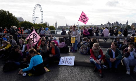Protesters sit down on Waterloo Bridge, blocking the bridge during a protest in London.