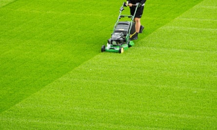 A groundsman cuts the grass at Ashton Gate stadium, Bristol