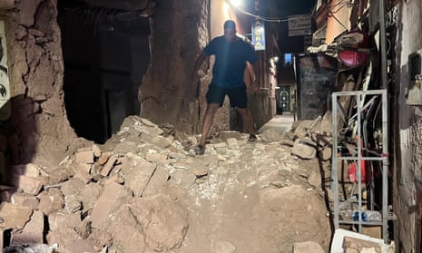 A man climbs over rubble in the old town.