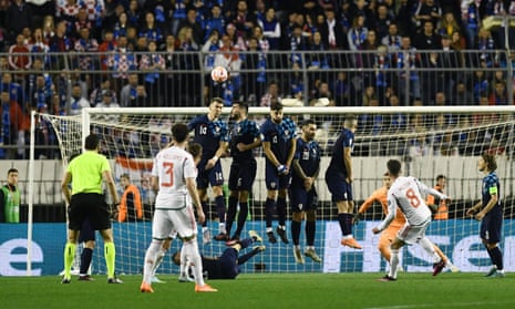 Croatia's defenders jump to head the ball during a Wales free kick.