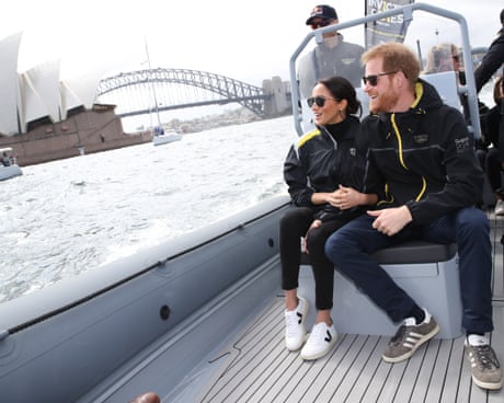 Prince Harry, Duke of Sussex and Meghan, Duchess of Sussex on Sydney Harbour looking out at Sydney Opera House and Sydney Harbour Bridge