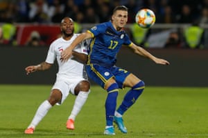 Benjamin Kololli holds off England’s Raheem Sterling