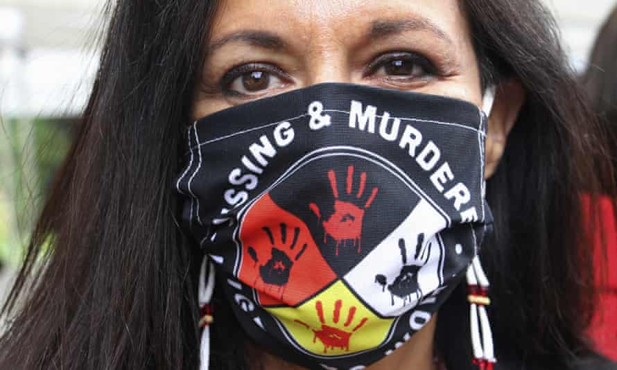 Jeannie Hovland, Deputy Assistant Secretary for Native American Affairs for the US Department of Health and Human Services, poses with a mask of missing and murdered Native women, in Anchorage, Alaska.