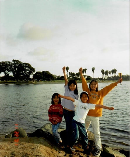My siblings and I pose in front of a lake in Southern California in November 2001, nine months into our move to the US.