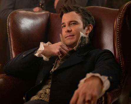 Luke Thompson as Benedict Bridgerton reclining in an armchair