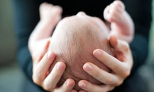 Mother holding her 2 month old baby.