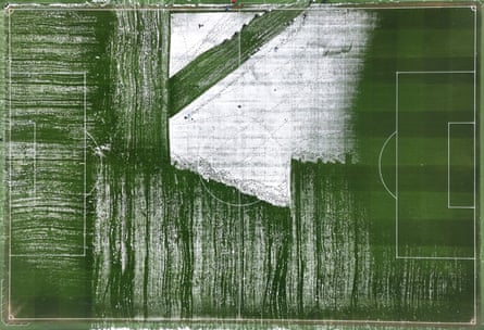 An aerial view of the Anfield pitch covered in snow before the Premier League match between Liverpool and Manchester United