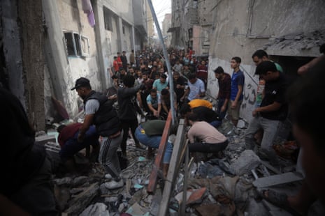 People search for victims amid the rubble of houses hit by Israeli bombing in Rafah in the southern Gaza Strip, on Saturday, November 11, 2023.