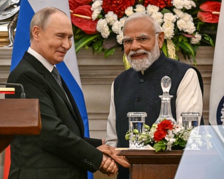 Russia’s President Vladimir Putin (L) speaks with India’s prime minister Narendra Modi after their joint press statements at the Hyderabad House in New Delhi