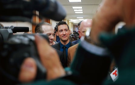 a man with cameras around him
