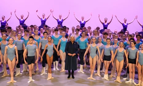 Camilla, the Queen Consort stands on stage with students during a visit to Elmhurst Ballet School