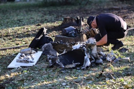 A police officer inspects fragments of a rocket after a Russian missile attack in Zaporizhzhia, Ukraine, on Saturday.