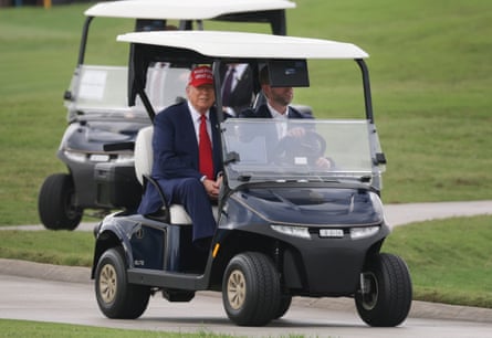 President Donald Trump and his son Eric in a golg cart