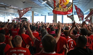 Bayern Munich fans greet the team coach as it pulls up at the Allianz Arena.
