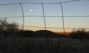 A barbed wire fence stretches along the US-Mexico border near Arivaca, Arizona.