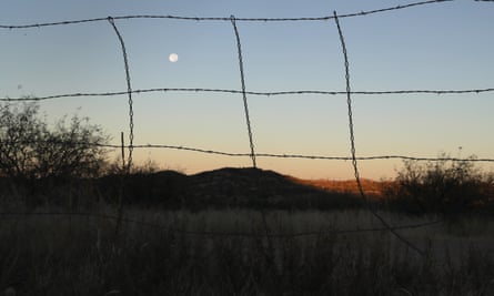 A barbed wire fence stretches along the US-Mexico border near Arivaca, Arizona.