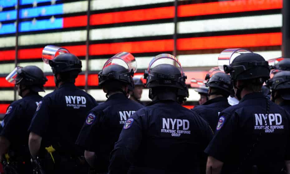 US-POLITICS-POLICE-JUSTICE-RACISM-minorities-demonstration<br>NYPD police officers watch demonstrators in Times Square on June 1, 2020, during a “Black Lives Matter” protest. - New York’s mayor Bill de Blasio today declared a city curfew from 11:00 pm to 5:00 am, as sometimes violent anti-racism protests roil communities nationwide. Saying that “we support peaceful protest,” De Blasio tweeted he had made the decision in consultation with the state’s governor Andrew Cuomo, following the lead of many large US cities that instituted curfews in a bid to clamp down on violence and looting. (Photo by TIMOTHY A. CLARY / AFP) (Photo by TIMOTHY A. CLARY/AFP via Getty Images)