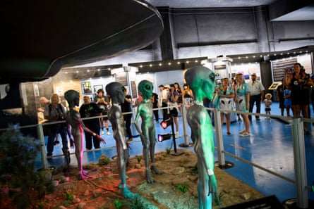 People take pictures of exhibits at the International UFO Museum and Research Center in Roswell, New Mexico.