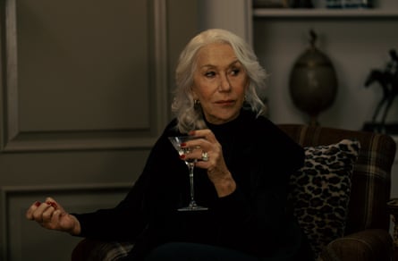 Helen Mirren holds a wineglass, looking waspish