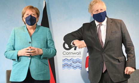 Johnson attempts to bump elbows with German chancellor Angela Merkel before their meeting on Saturday.