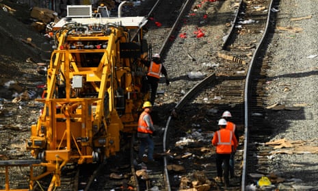 Railroad workers repair a section of Union Pacific train tracks after a train derailed from the tracks.
