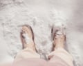 Snow-covered boots on a sunny winter day