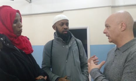Nigel Bromage (right) talks with members of the Muslim Welfare House congregation.