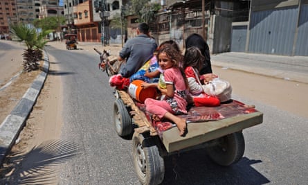 A Palestinian family flees their home in Beit Lahya in the northern Gaza Strip