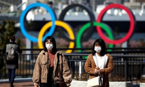 People wear face masks in Tokyo as a Japanese woman was diagnosed with Covid-19 for the second time. 