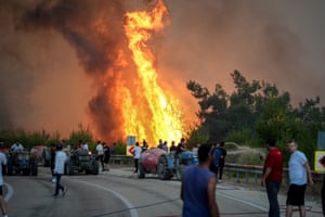 Firefighters and civilians battle a forest fire that broke out in the woodland area between the districts of Gursu and Kestel in Bursa