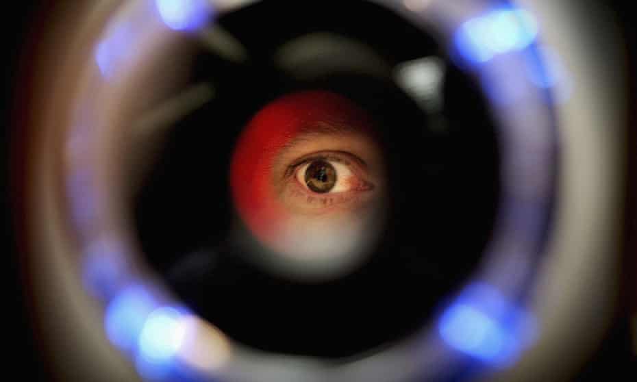 A man uses an iris recognition scanner during the Biometrics 2004 exhibition and conference