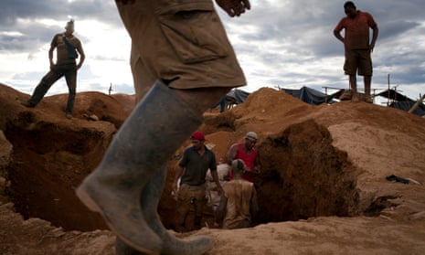 Miners dig in the earth in search of gold in a makeshift camp for illegal mining near Tumeremo in Venezuela's southern Bolívar.