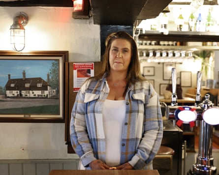 Emma Smith stood behind the bar of her pub
