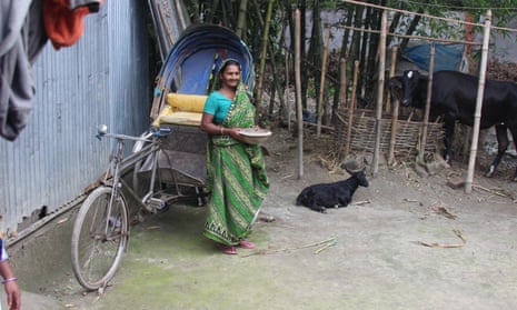 Tulsi stands in the courtyard of her hut in the village of Outpara in Bangladesh