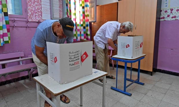 Two Tunisians fill out ballots