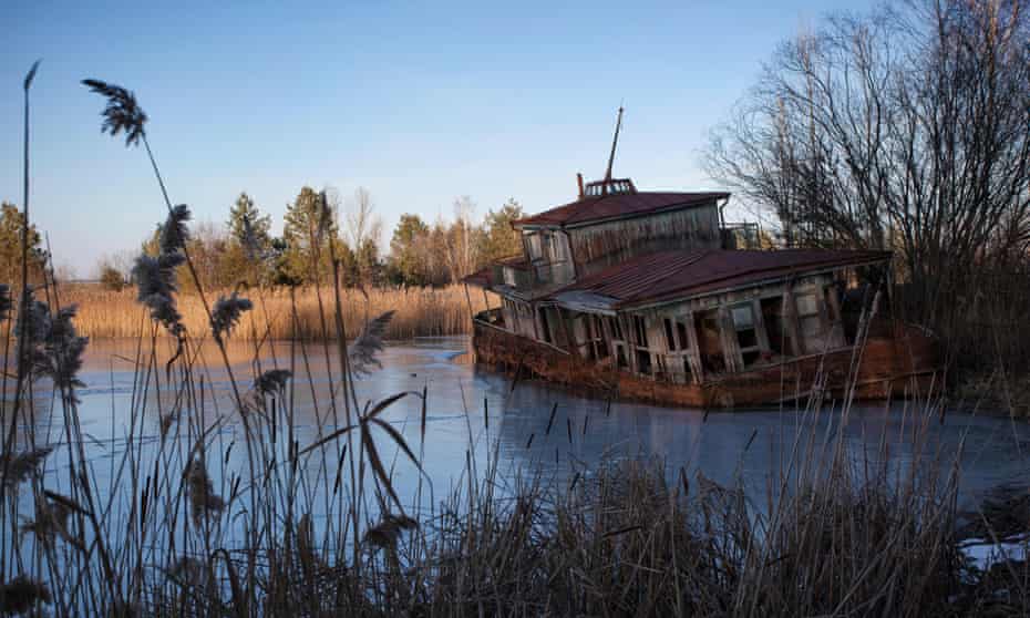 bandoned shipwreck on the banks of the Pripyat River after the Chernobyl disaster.
