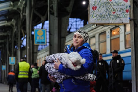 A woman with her child seen at Lviv railway station as she tries to flee from Ukraine to Poland