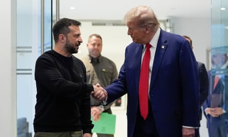Zelenskyy and Trump shake hands.