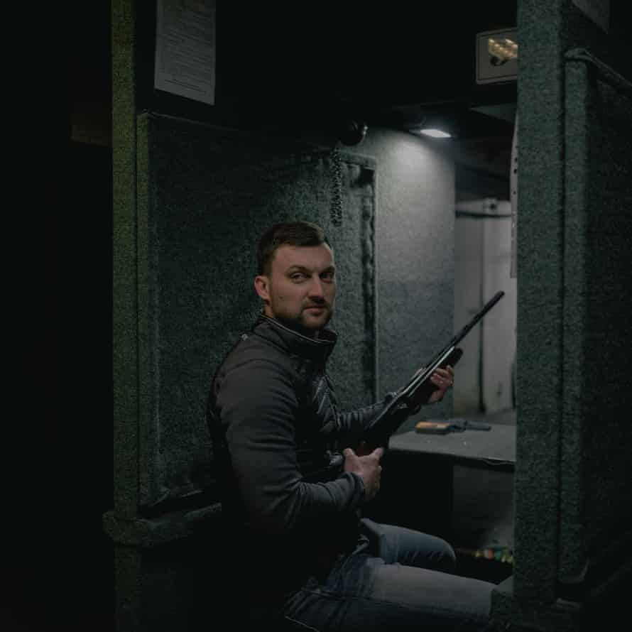 Roman, 31, poses with his rifle in the shooting range of a training location in Lviv, 9 March