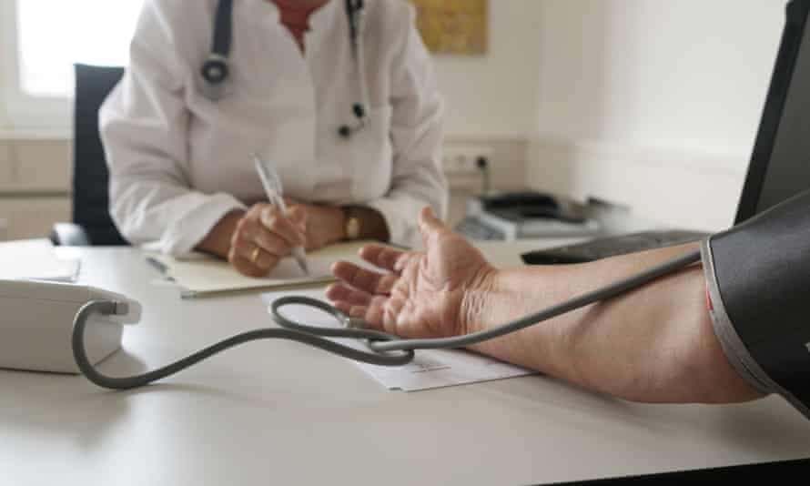Doctor examines the blood pressure of a patient