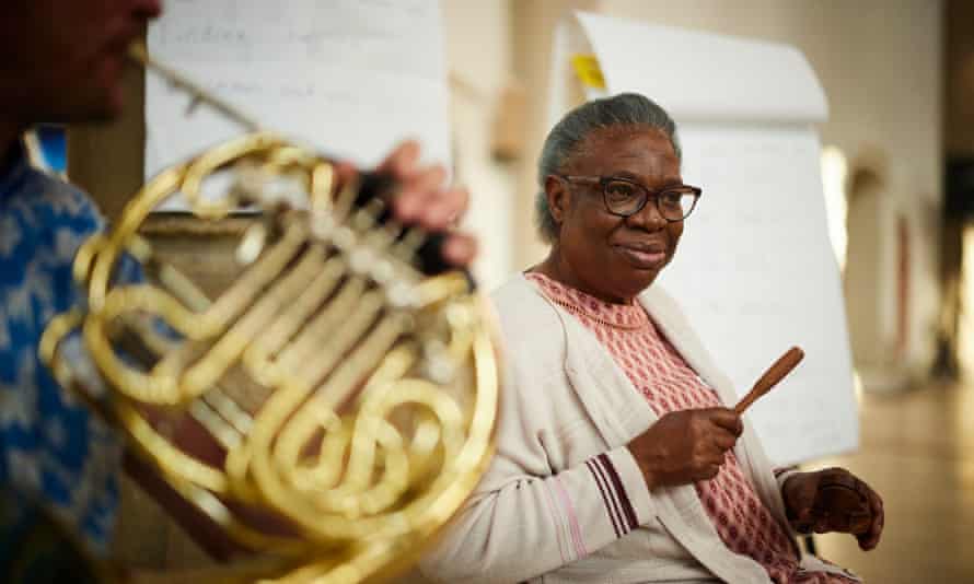 ‘Spiritual medicine’: orchestra helps people with dementia write music 1 A woman attending the music cafe, with tuba player in foreground