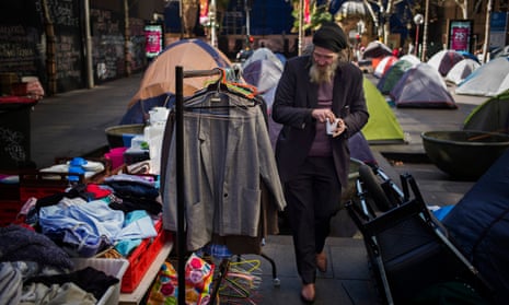 A homeless man examines donated clothing in Sydney’s Martin Place.